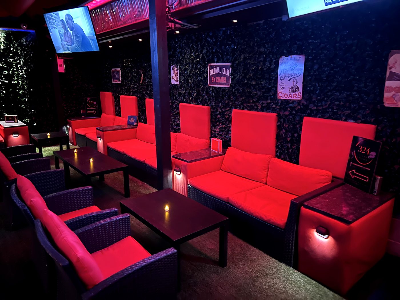 Red lounge seating and low tables at 324 Cigar Lounge